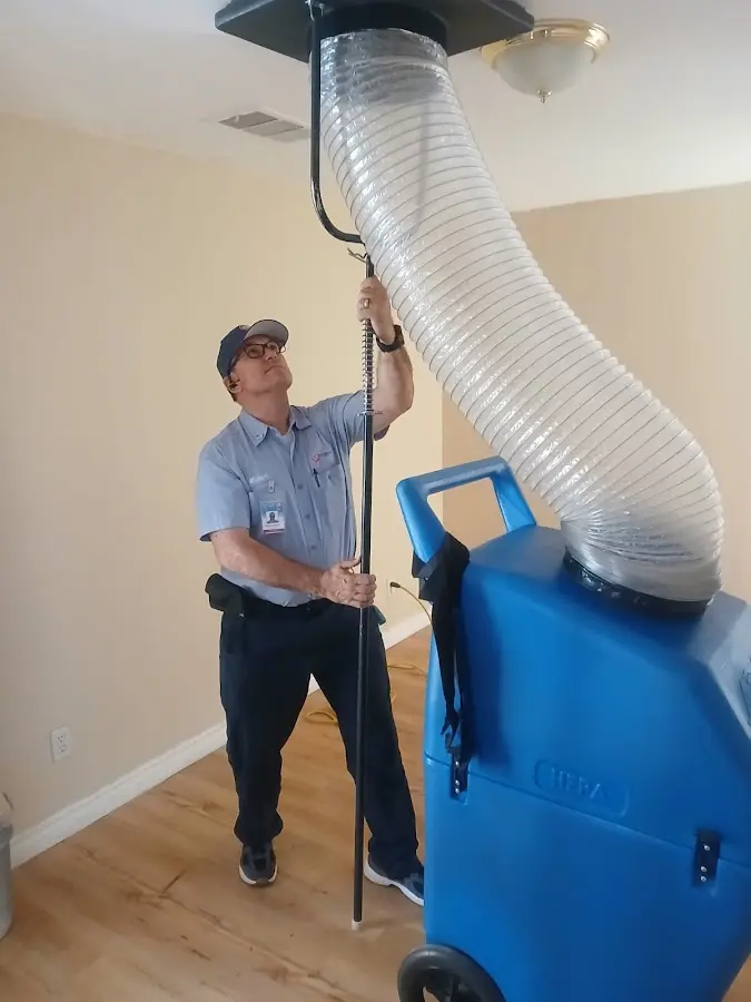 Furnace Tune-Up technician using HEPA equipment in Sanford